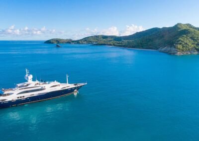 Aerial photo of yacht on the water near an island.