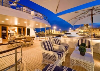 Evening setting on deck of superyacht with seating and dining area designed by Fort Lauderdale yacht designer Patrick Knowles